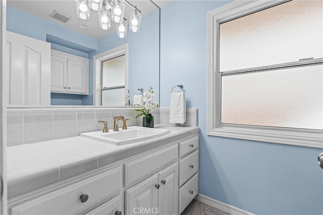 bathroom featuring a healthy amount of sunlight and vanity