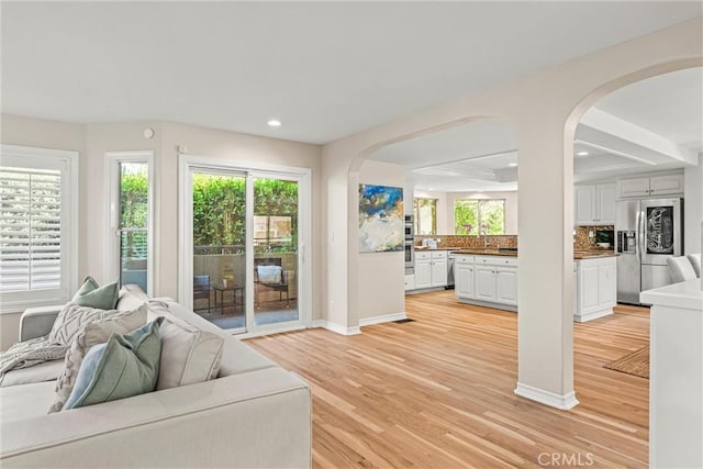 living room featuring light wood-type flooring and sink