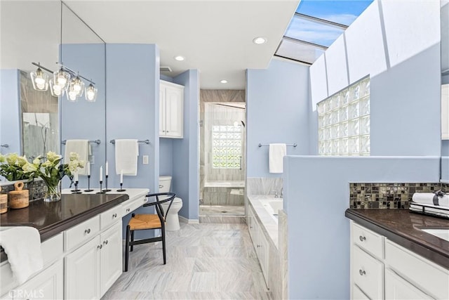 full bathroom featuring toilet, vanity, and separate shower and tub