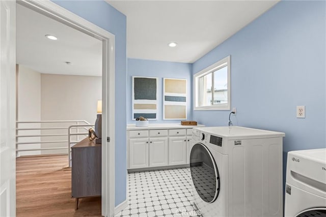 laundry room featuring cabinets and separate washer and dryer