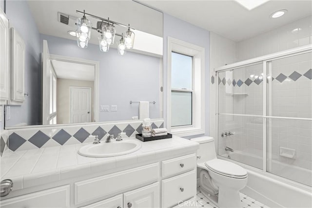 full bathroom with toilet, combined bath / shower with glass door, decorative backsplash, and vanity