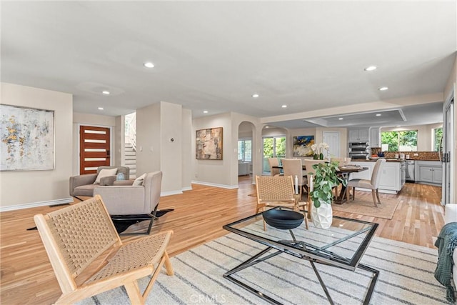 living room featuring a wealth of natural light and light hardwood / wood-style flooring