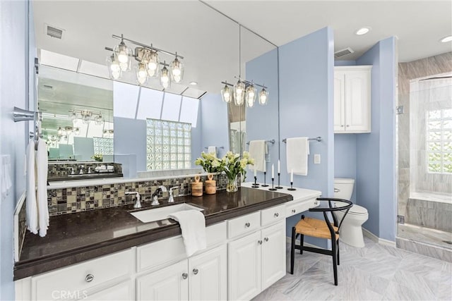 bathroom featuring an enclosed shower, vanity, decorative backsplash, and toilet