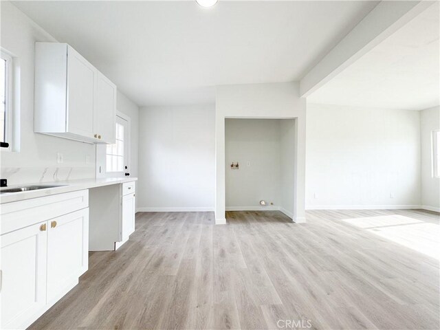 kitchen featuring white cabinetry and light hardwood / wood-style floors