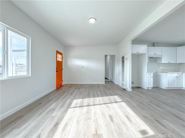 unfurnished living room with light wood-type flooring