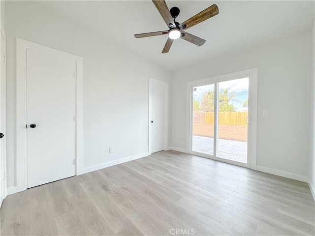 unfurnished room with ceiling fan and light wood-type flooring