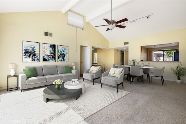 living room featuring ceiling fan, carpet, track lighting, high vaulted ceiling, and beam ceiling