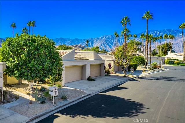 view of front of home featuring a mountain view and a garage