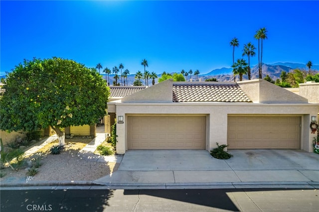 view of front facade with a mountain view and a garage