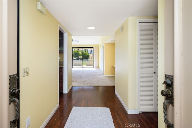 corridor with dark hardwood / wood-style flooring