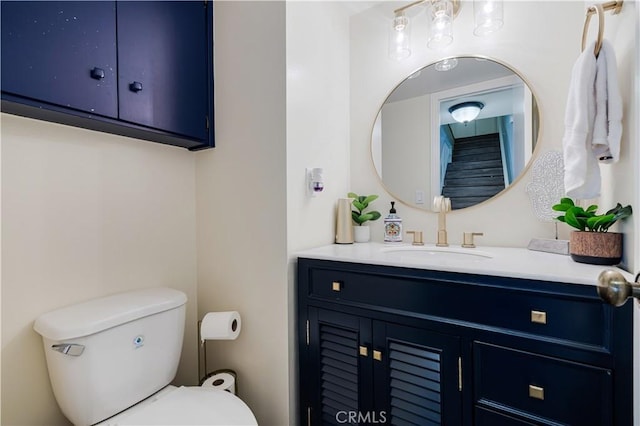 bathroom with toilet and vanity