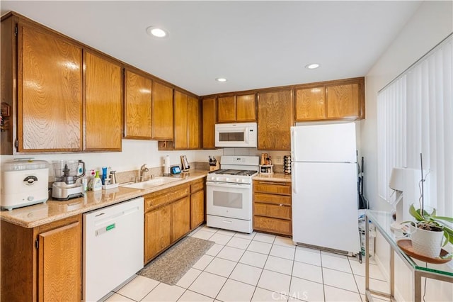 kitchen featuring sink, white appliances, and light tile patterned floors