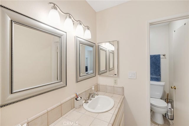 bathroom featuring toilet and vanity