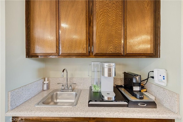 kitchen featuring light stone countertops and sink