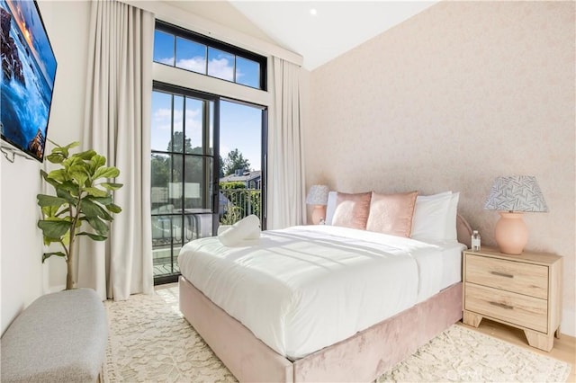 bedroom with access to exterior and lofted ceiling