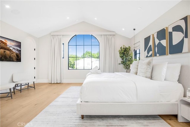 bedroom featuring vaulted ceiling and light hardwood / wood-style flooring