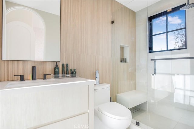 bathroom featuring a shower, tile patterned floors, toilet, and vanity