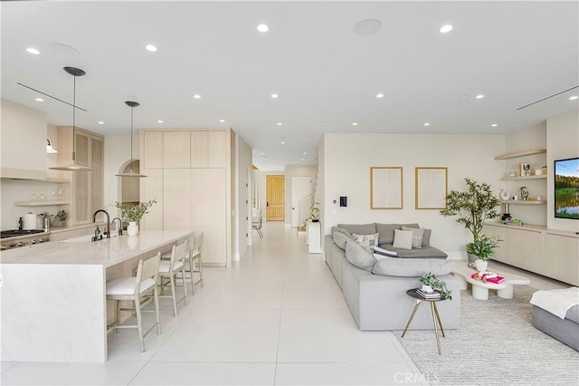 living room with light tile patterned floors and sink