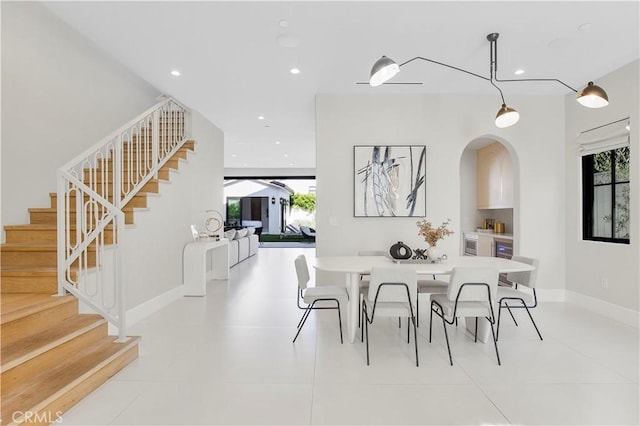 dining room with light tile patterned floors and wine cooler