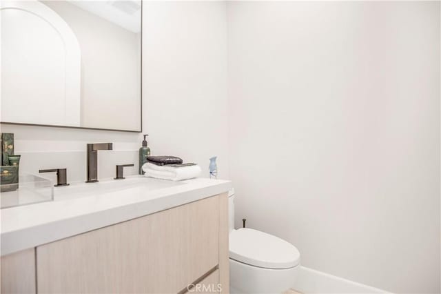 bathroom featuring toilet and vanity