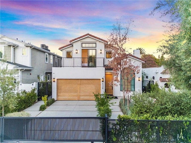 view of front of house featuring a balcony and a garage