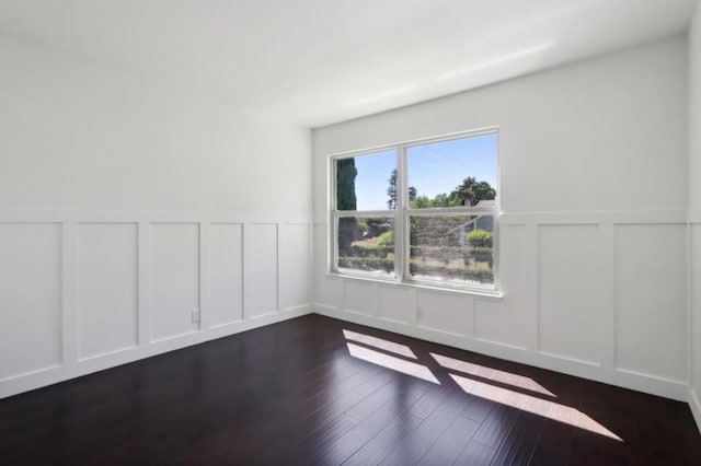 empty room with dark wood-type flooring