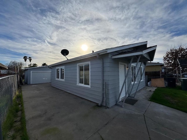 property exterior at dusk with an outbuilding and a garage