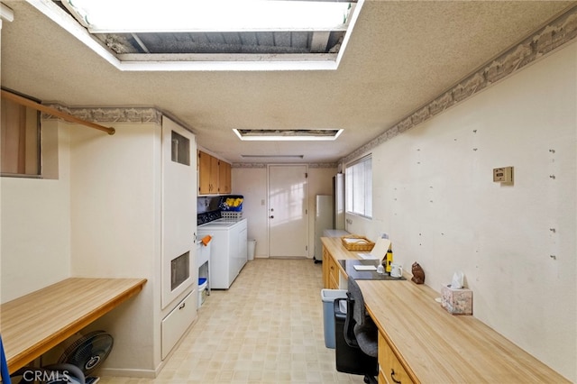 kitchen with independent washer and dryer and stainless steel refrigerator