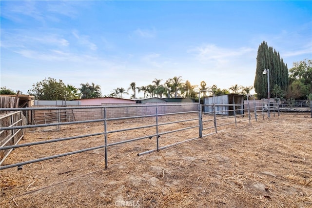 view of yard with a rural view and an outdoor structure