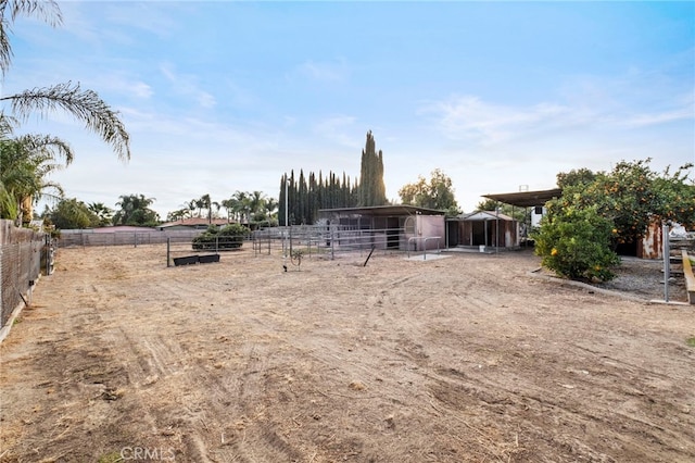 view of yard with a rural view and an outdoor structure