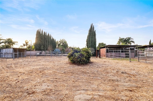 view of yard with a rural view and an outdoor structure