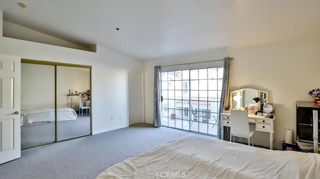 carpeted bedroom featuring vaulted ceiling and a closet