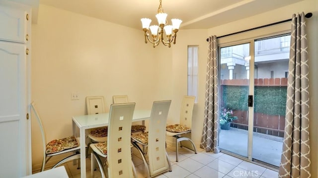 tiled dining room featuring a notable chandelier