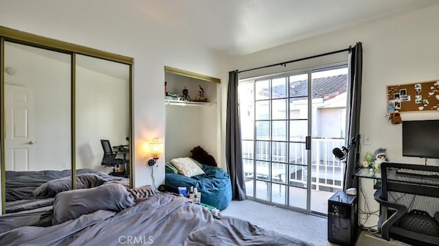 bedroom featuring carpet, a closet, and access to outside