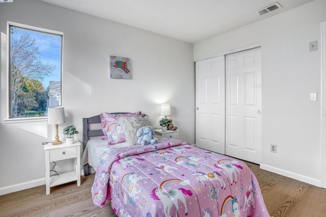 bedroom with a closet and hardwood / wood-style flooring