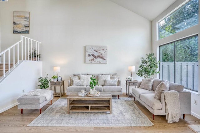 living room featuring hardwood / wood-style flooring and high vaulted ceiling