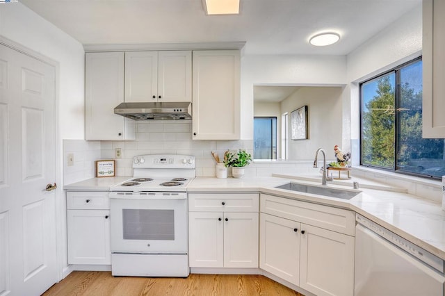 kitchen featuring white cabinetry, sink, and white appliances