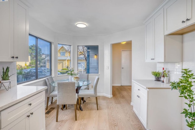 dining space featuring light wood-type flooring