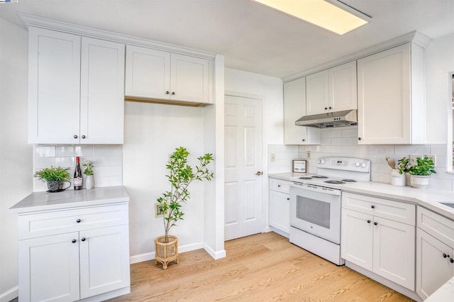 kitchen with light hardwood / wood-style flooring, white cabinets, white electric range oven, and tasteful backsplash