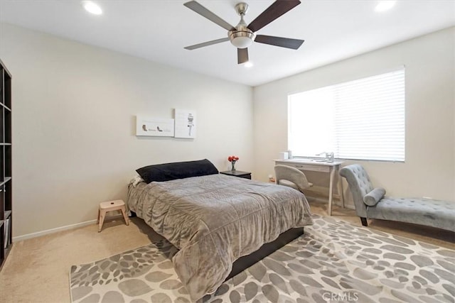 bedroom featuring light carpet and ceiling fan