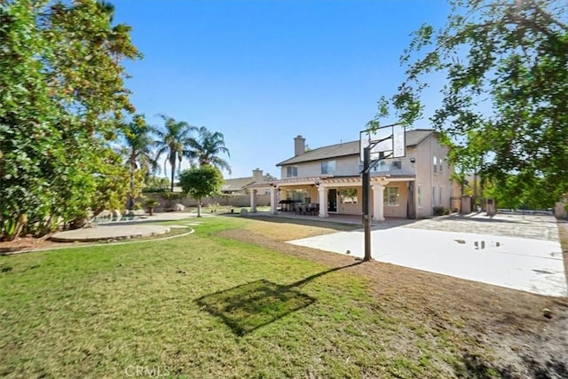 view of yard with basketball court and a patio