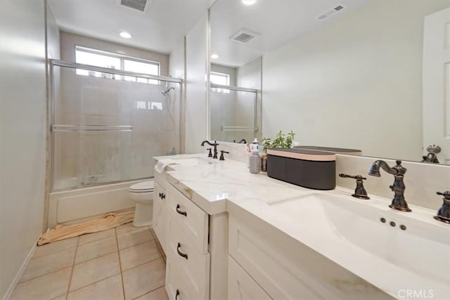 full bathroom with toilet, enclosed tub / shower combo, vanity, and tile patterned floors