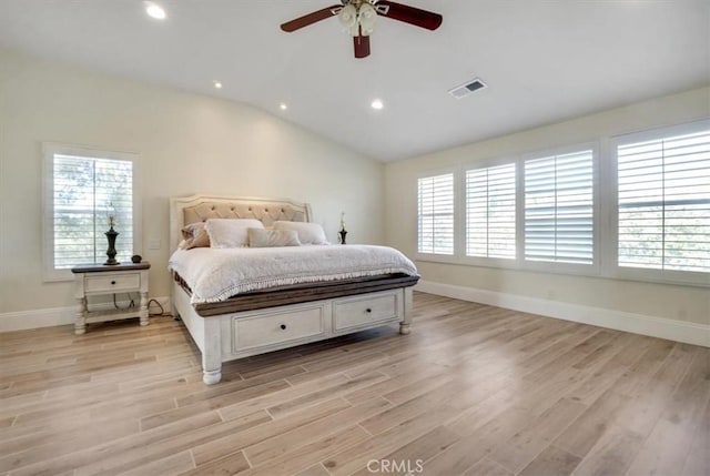 bedroom featuring ceiling fan, lofted ceiling, light hardwood / wood-style floors, and multiple windows