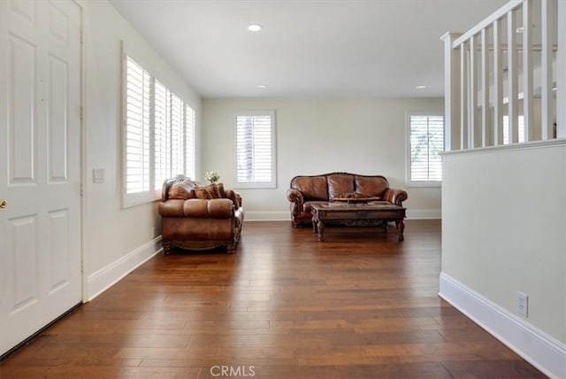 living area with dark hardwood / wood-style flooring and a wealth of natural light