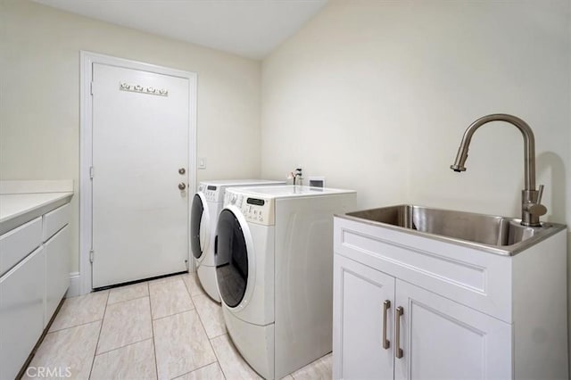 laundry room with cabinets, light tile patterned floors, independent washer and dryer, and sink