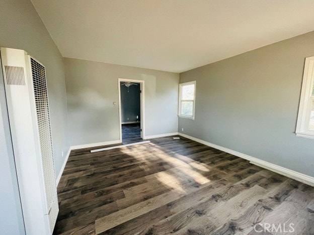 unfurnished bedroom with dark hardwood / wood-style floors