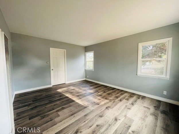 spare room with dark wood-type flooring