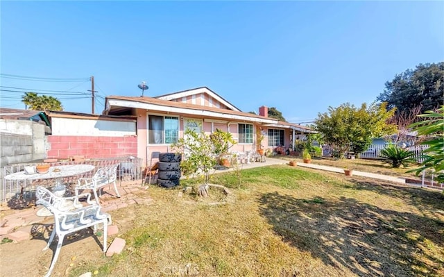 single story home with a front lawn and a patio area