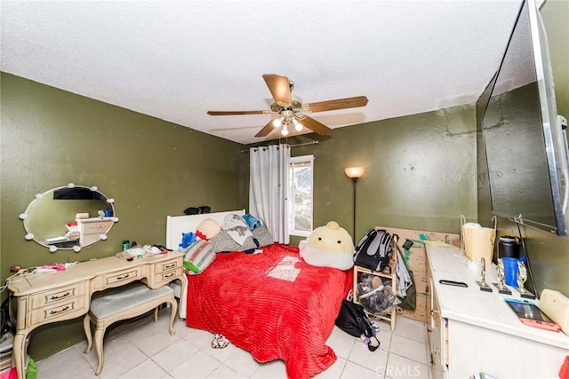 bedroom with a textured ceiling, ceiling fan, and light tile patterned floors