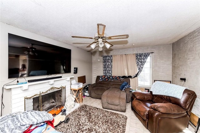 living room featuring ceiling fan and a textured ceiling